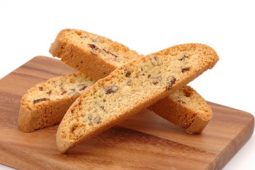 Delicious orange cranberry biscotti served on a wooden board.