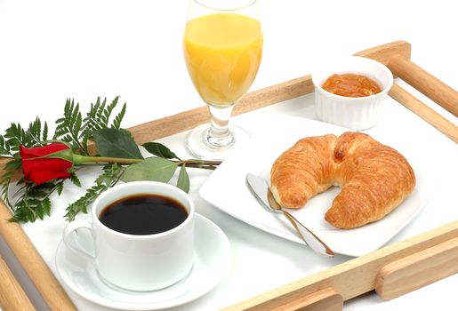 Romantic breakfast tray with coffee and a croissant.