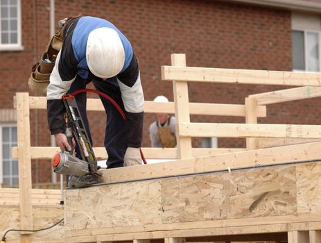 Carpenter framing a new home.