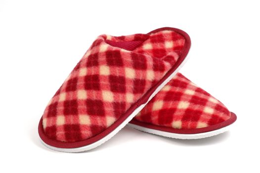 Cozy and warm tartan slippers on a white background.