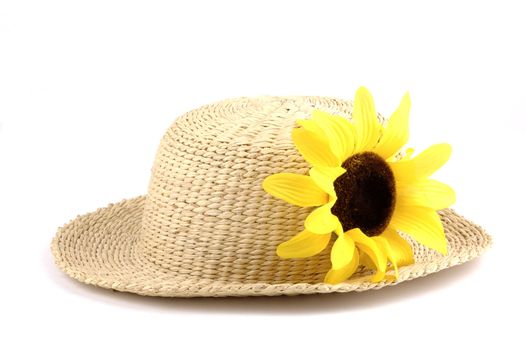 Straw hat with a bright yellow sunflower.