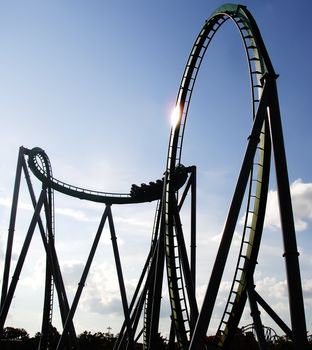 Steel Built Sitdown Rollercoaster Against Blue Sky                              