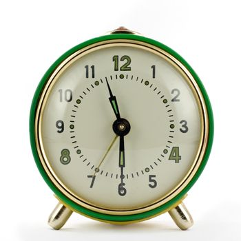 Vintage mechanical wind-up alarm clock over white isolated