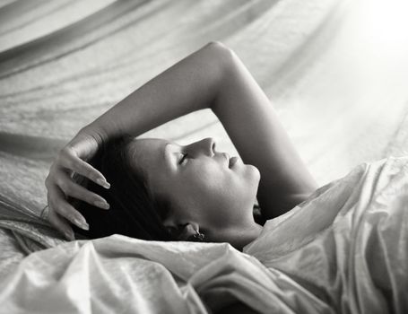 Black and white image of pretty woman sleeping peacefully