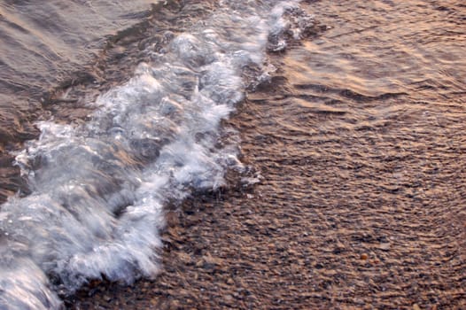 closeup of sea surf at sunset