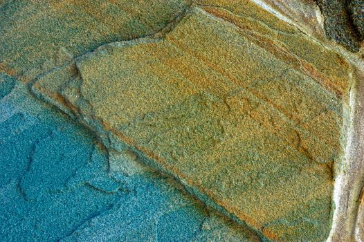 colored (prevaling blue and brown) rough stone surface