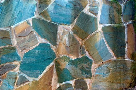 colored (prevaling blue) rough wall surface made of wild stones