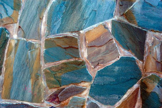 colored (prevaling blue) rough wall surface made of wild stones