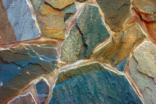 colored rough wall surface made of wild stones