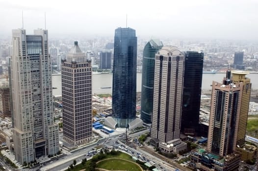 Aerial view of Shanghai city, general cityscape with modern skyscrapers in Pudong and Huangpu River.