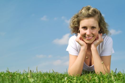 A beautiful lady sitting on the grass in sunny day