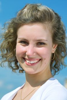 Beautiful lady in white smiling over sky