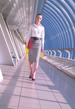 Portrait of beautiful young business woman with red folder