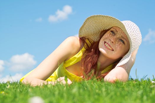 Beautiful lady in yellow dress relaxing in the park