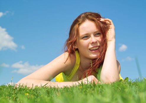 Beautiful lady in yellow dress relaxing in the park