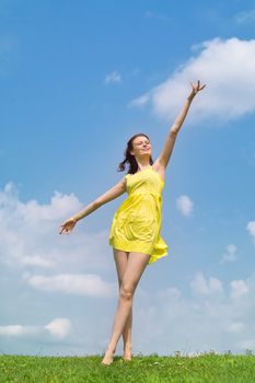 Beautiful lady in yellow dress relaxing in the park