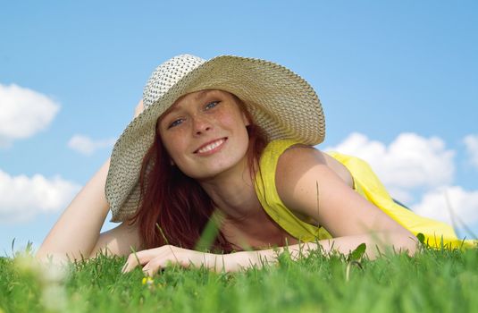 Beautiful lady in yellow dress relaxing in the park