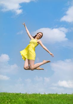Beautiful lady in yellow dress and hat jumping 