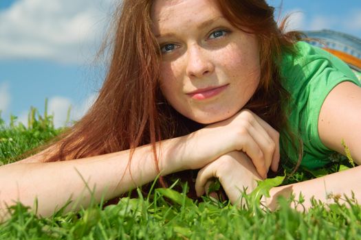 Beautiful lady in green relaxing in the park