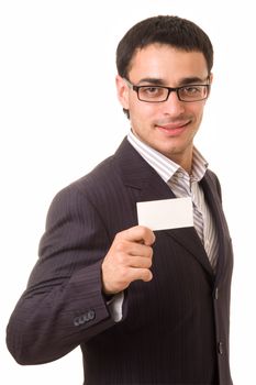 Young businessman holds an empty business card, isolated on white background.