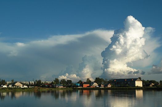 Provincial small town on the bank of a reservoir in the summer evening