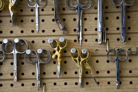 A display of fancy scissors and sewing tools.