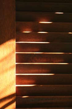 Brown shutters with dust in evening light.