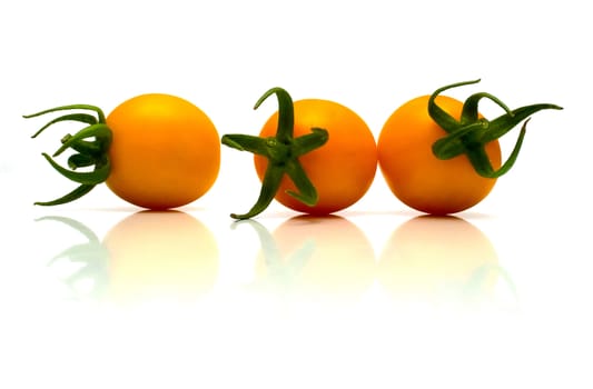 perfect yellow tomatoes on the white. Full isolation, shallow DOF.