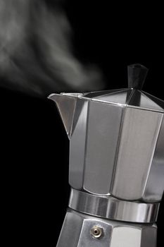Image of an Italian Moka Express stovetop coffee maker blowing steam out its spout.
