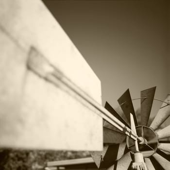 An ornamental garden windmill up close near the wind vane.