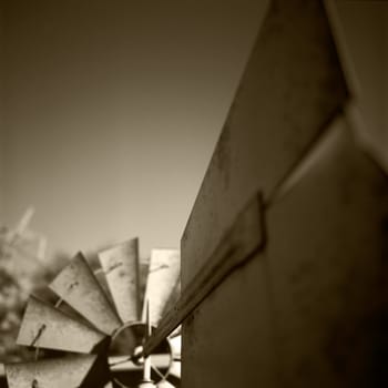 An ornamental garden windmill up close near the wind vane.