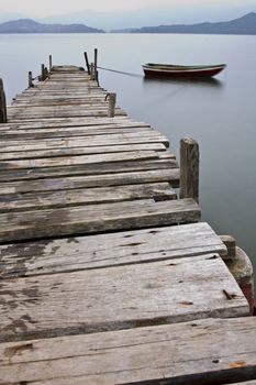 Looking over a desolate peer and a boat
