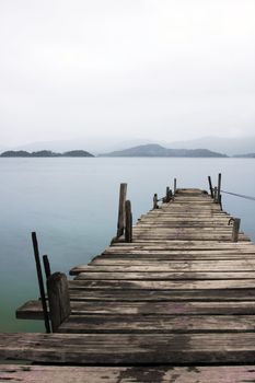 Looking over a desolate peer and a boat
