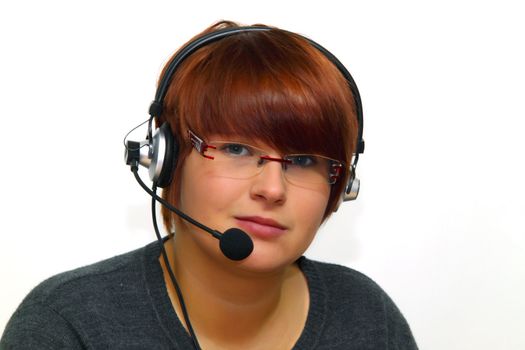 Portrait of young woman with headset, on white background, smiling.