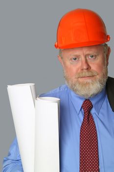 Architect with blueprints and hard hat on grey background
