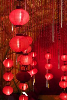 Big red lanterns with chinese letters printed. It brings good luck and peace to prayer. It was at night in a chinese temple during Chinese New Year.