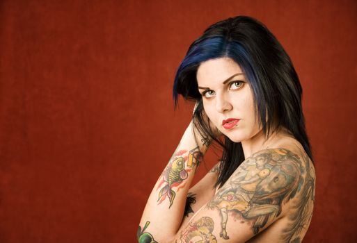 Pretty young woman with many colorful tattoos