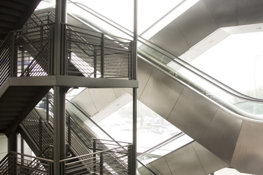 it is a modern escalator and a tradition stairs, made a composition.