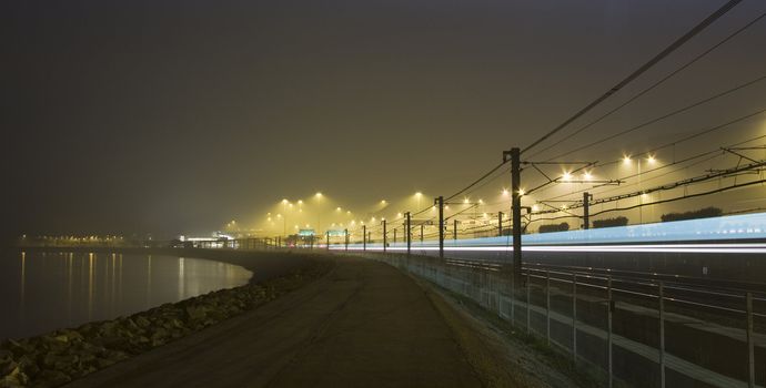 Rails by night with reflecting neon light.