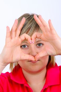 Young woman hand signal showing heart on white background