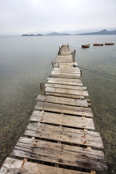 Looking over a desolate peer and a boat 