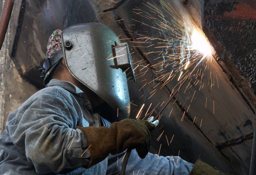 a metal welder busy at work