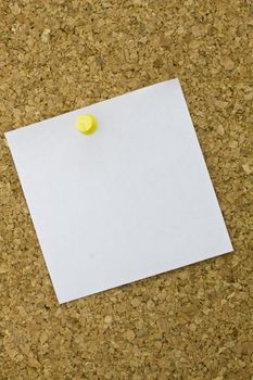 Yellow postit on a everyday corkboard. This is my corkboard. 