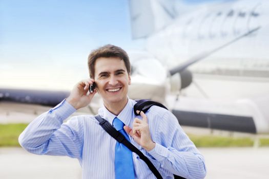 Businessman on airport with a mobile phone