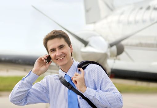 Businessman on airport with a mobile phone