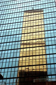 Hongkong Central - city center with modern skyscraper, one building reflected by another.