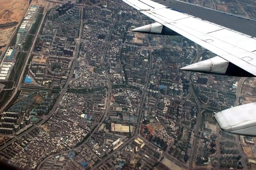 Shenzhen city - aerial view of crowded chinese metropolis, modern buildings, factories, residential zones and offices.