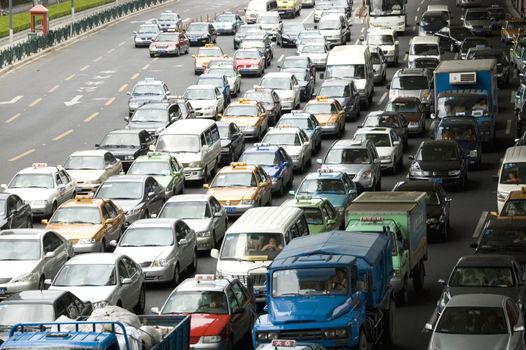 Shanghai city, China. Wide road full of cars, waiting in common traffic jam.