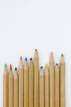 Colored pencils forming a color row. White background.