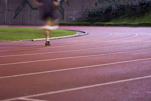 It is a man running in play gorund lanes on a track